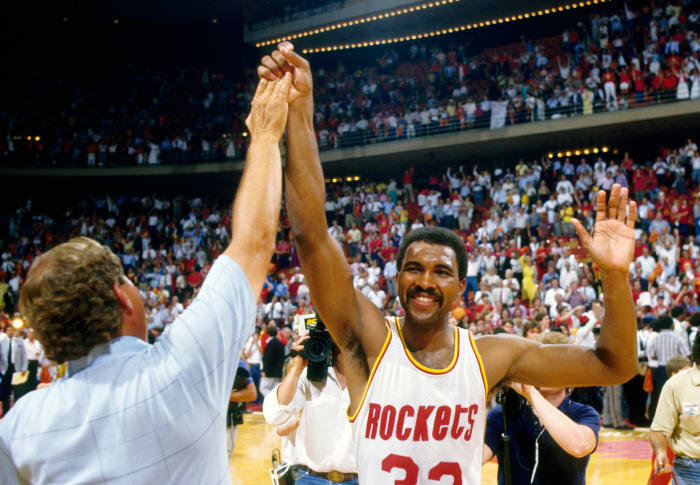 Houston Rockets forward Robert Reid (33) high fives a fan against the Boston Celtics in the 1986 NBA Finals at the Summit.